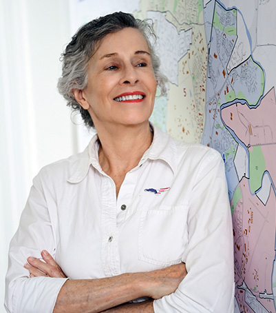Woman standing next to a map.